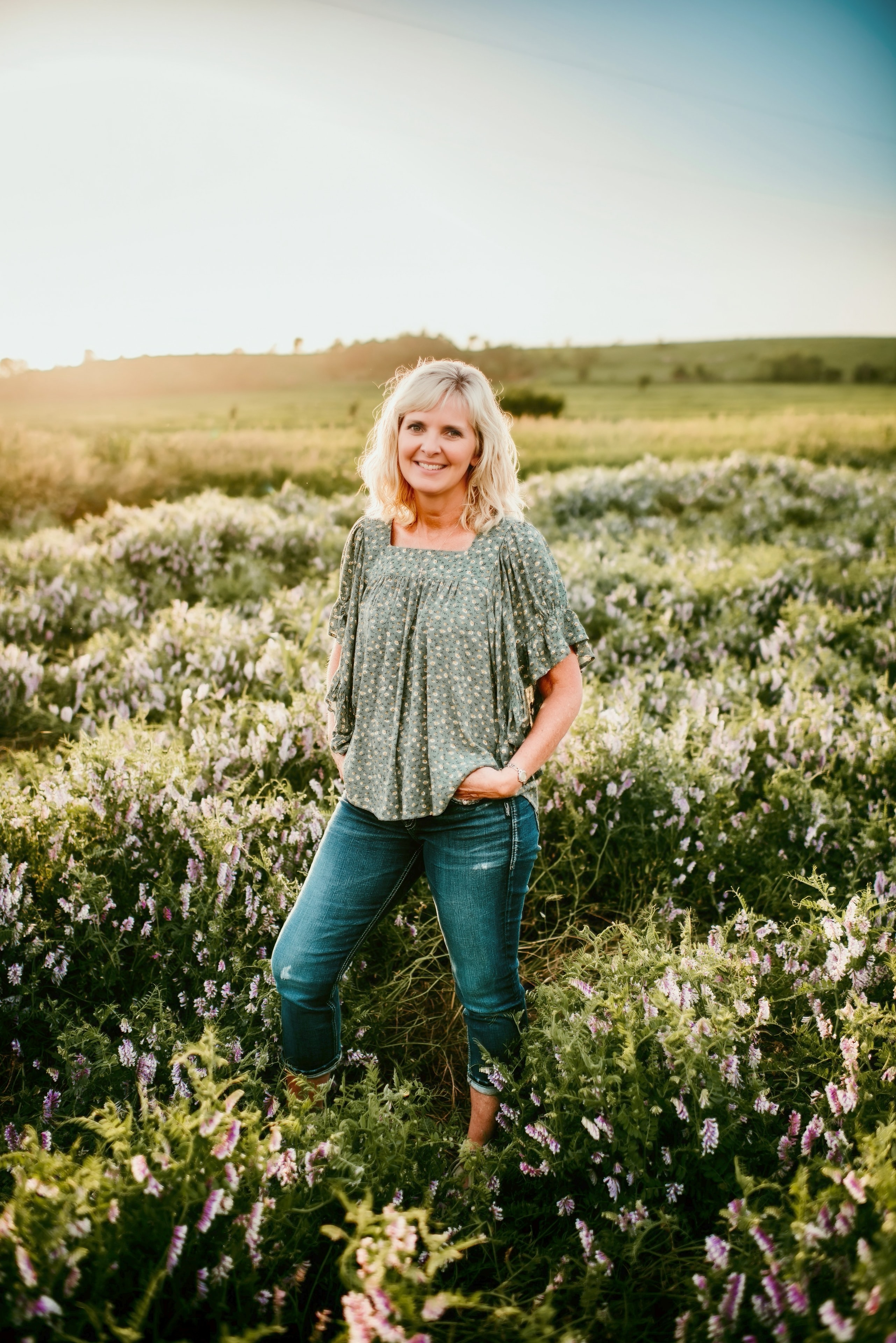 Debbie Feyh standing in a wildflower field