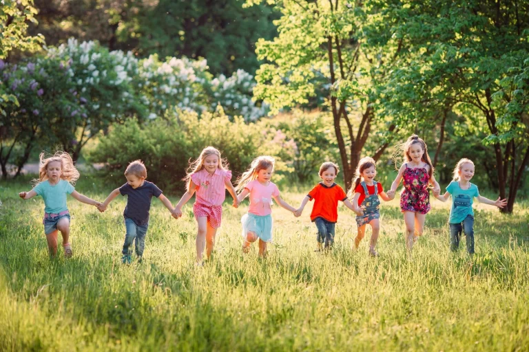 Group of kids running through a field.