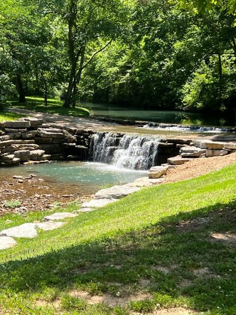 Small waterfall flowing through a forest.