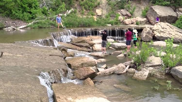 People enjoying a small waterfall.