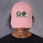 Woman wearing a pink "Go Experience Nature" hat.