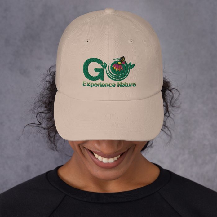 Person wearing a beige cap with "Go Experience Nature" logo.