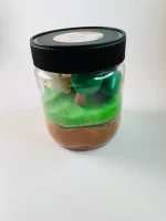 Jar of green and brown playdough.